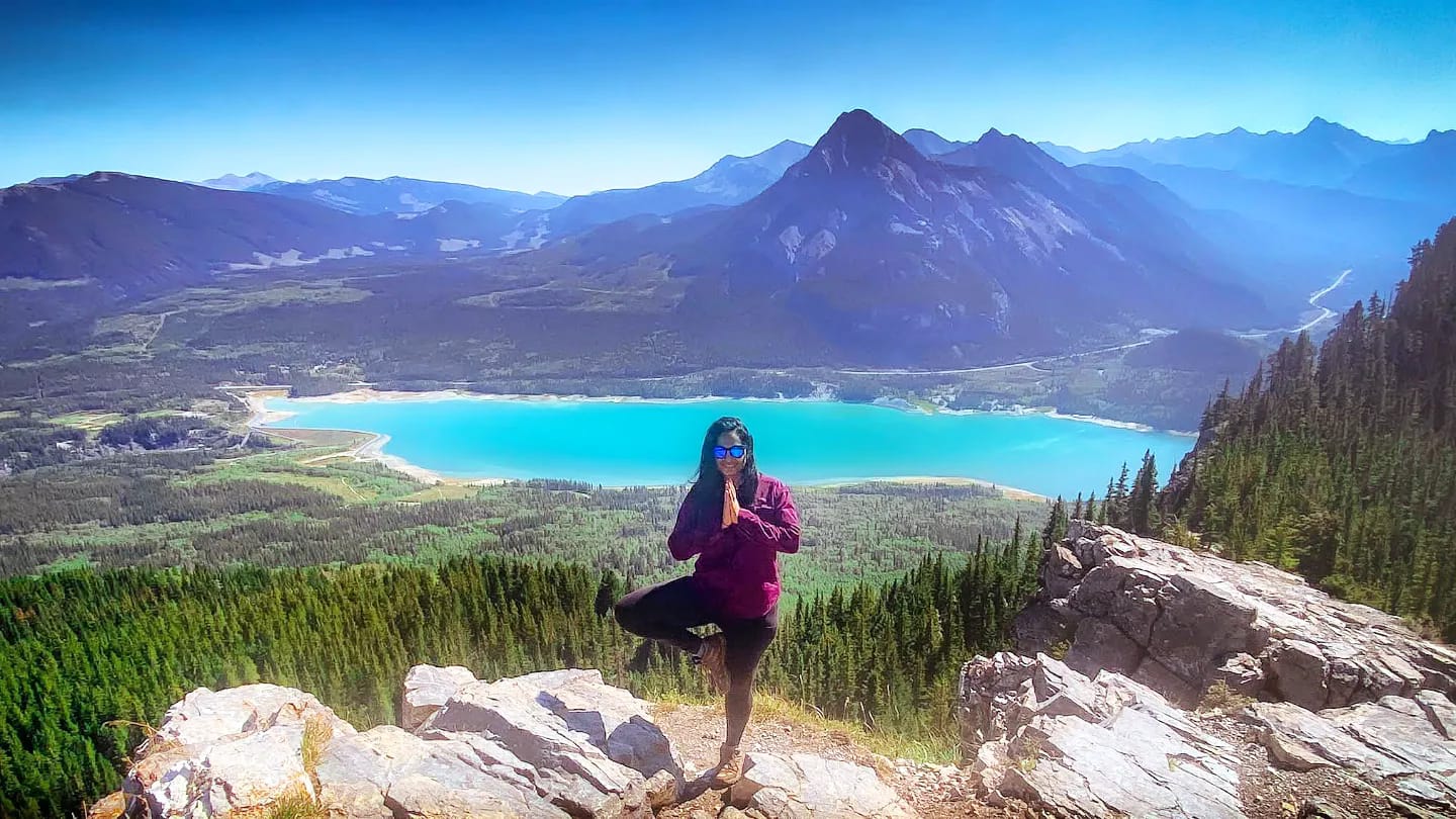 Aleefia in tree pose on a mountaintop